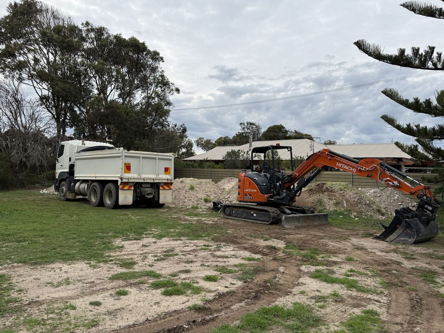 Angel Earthworks Hitachi excavator and Hino tipper truck on site